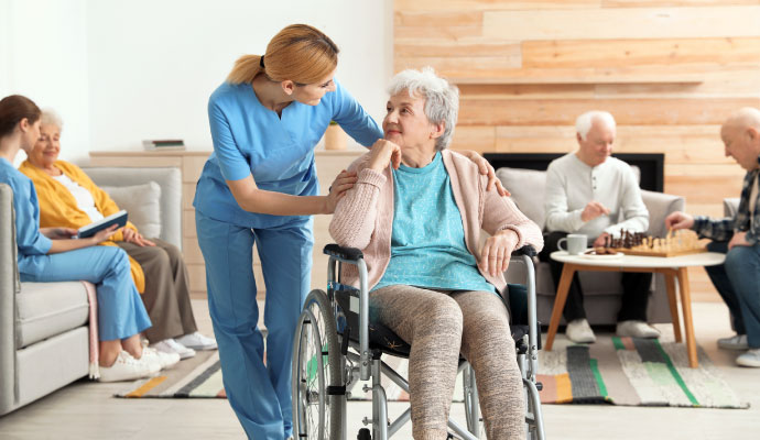 A nurse is assisting an elderly woman at assisted living facility