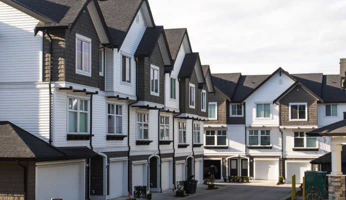 A row of modern three-story multi-family properties