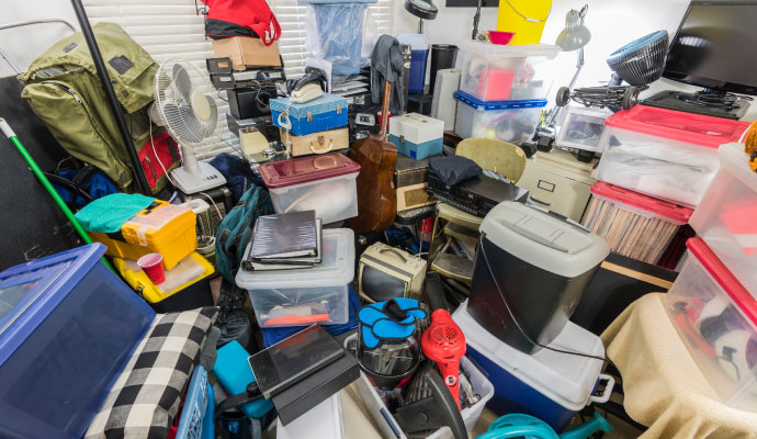 An extremely messy and cluttered room filled with household junk