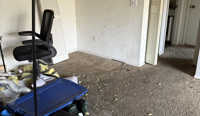 Bedroom showing significant fire damage with debris