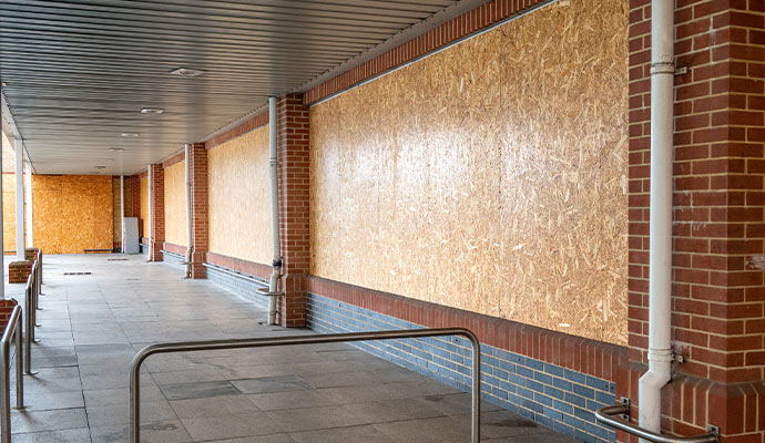 Boarded-up commercial building wall