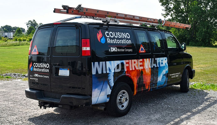 Cousino Restoration & Environmental van with wind fire water graphics