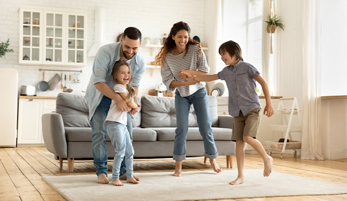 Happy family playing in bright living room