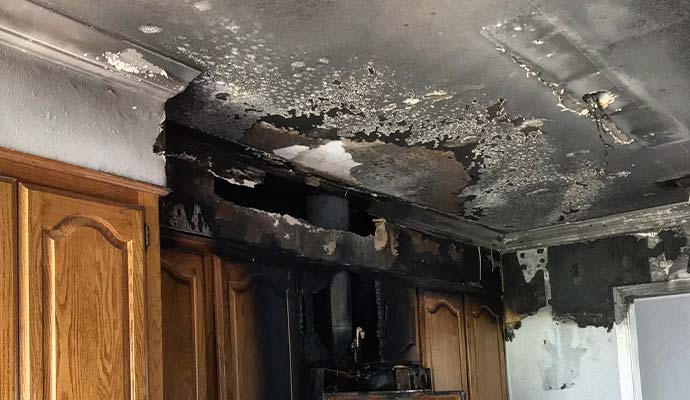 Structural fire damage on a kitchen ceiling