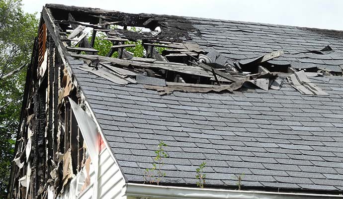 Lightning damaged residential roof with hole