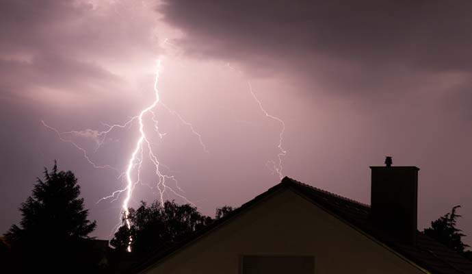 Lightning strike over house at night