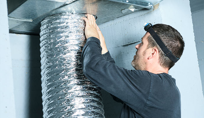 Person installing HVAC vent pipe