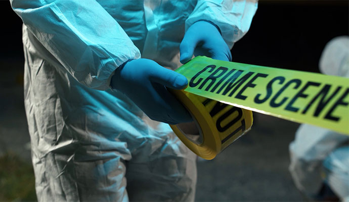 A professional sealing a crime scene for biohazard cleanup