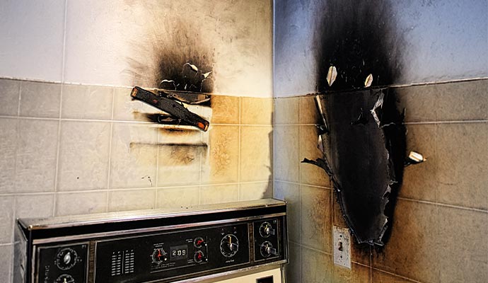 Smoke and soot damaged restaurant kitchen wall
