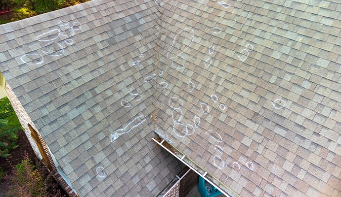 Hail damage spots marked on a roof