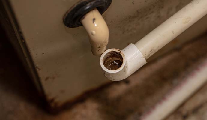 Clogged AC condensate drain line dripping water
