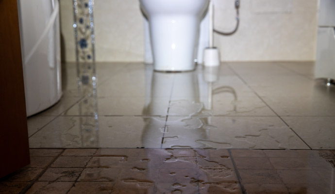 Flooded bathroom floor near toilet