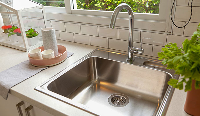 Stainless steel kitchen sink with chrome gooseneck faucet