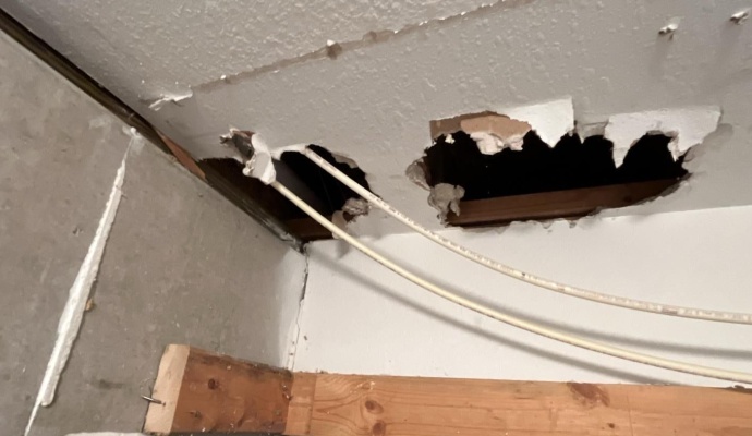 Water damaged ceiling with several large hole